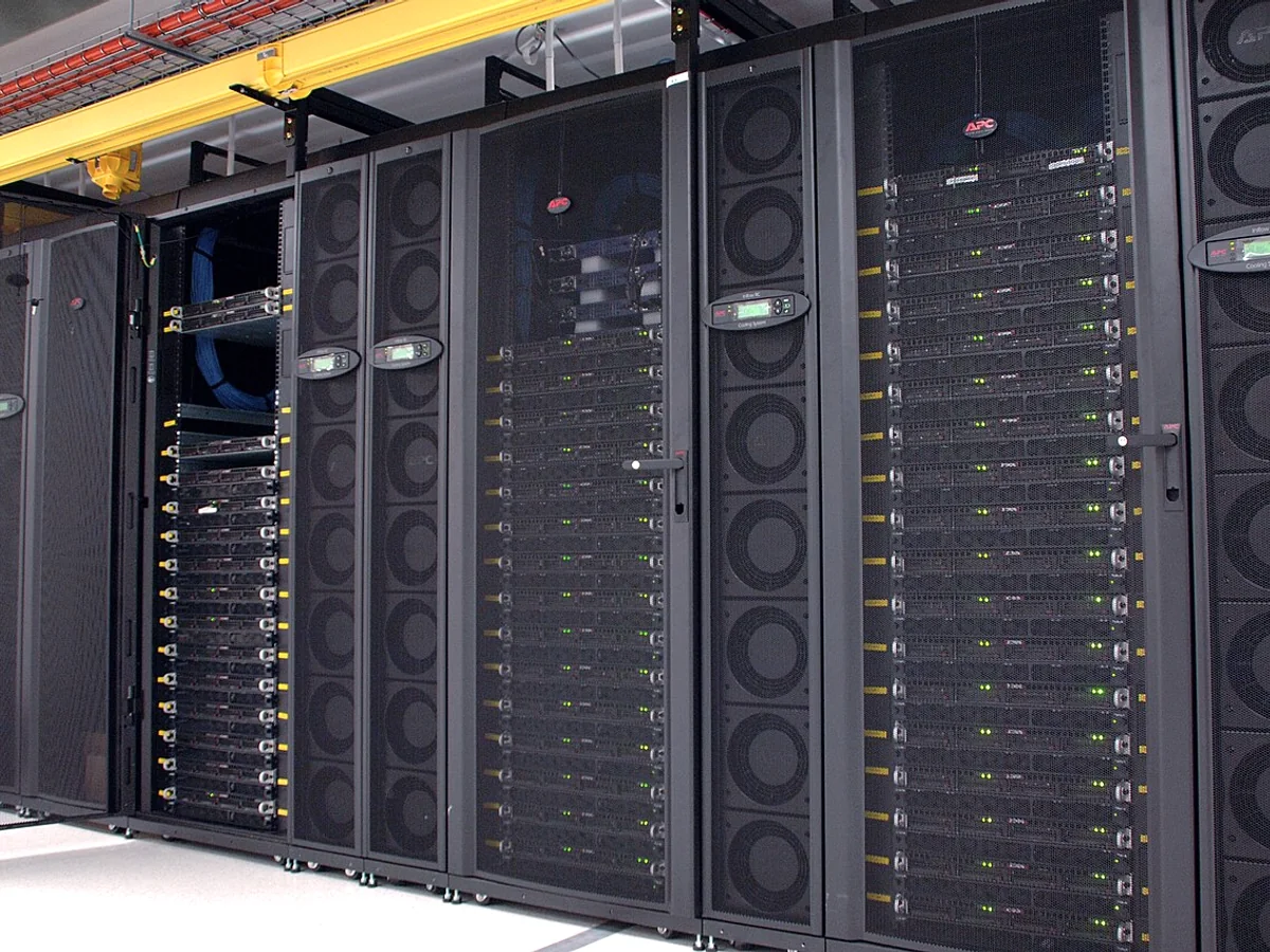 GPU computing cluster with server cabinets, cooling equipment, and overhead cable routes